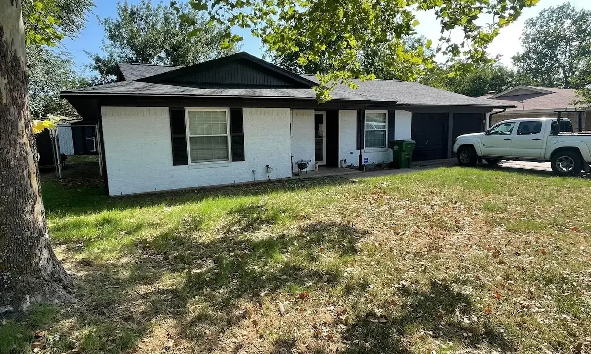Professional roofing crew working on a residential roof in Saks